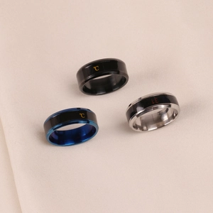 Polished smart temperature sensing stainless steel rings showing Celsius display on silk