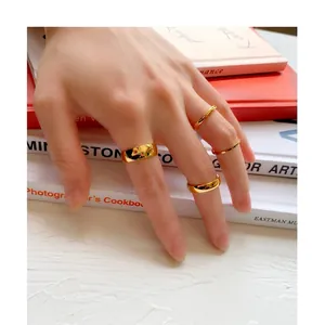 Set of four minimalist gold titanium steel rings with a polished mirror finish for women