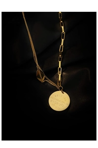 Macro shot of gold necklace with engraved Beloved pendant and asymmetric link chains