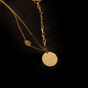 Golden multi-layer chain necklace with engraved circular pendant and OT clasp