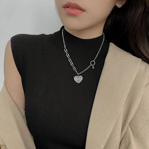 Detail of silver heart pendant with Forever engraving on asymmetric stainless steel chain