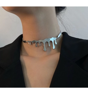 Detail view of silver liquid drip choker necklace with mirror finish on model