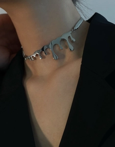 Minimalist fluid drip titanium steel necklace on model wearing a chic black blazer