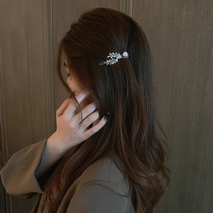 Elegant zircon leaf hair clip with pearls shown on model in a sophisticated style
