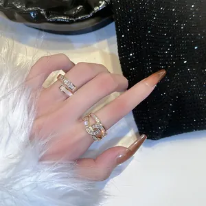 Detail of luxury gold rings featuring baguette zircon and woven chain diamond designs