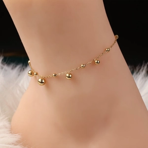 Minimalist gold beaded anklet with polished round charms on a delicate O-chain for women
