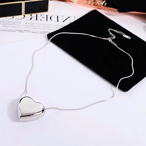 Detailed view of 3D polished heart pendant with sleek snake chain and lobster clasp