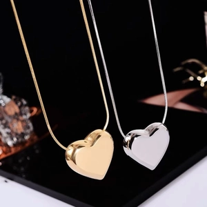 Minimalist gold and silver heart pendant necklaces with sleek snake chain design