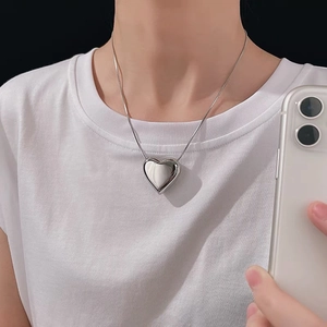 Minimalist silver heart pendant necklace with a sleek snake chain for women