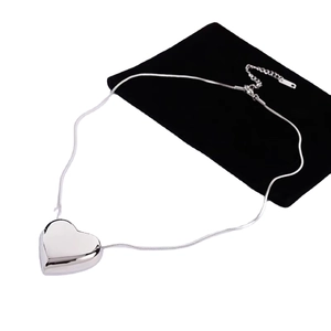 Minimalist silver heart pendant necklace with sleek snake chain and adjustable clasp