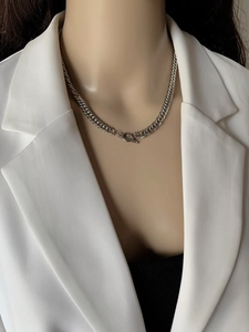 Close-up of silver titanium steel chunky chain necklace with a classic OT toggle clasp