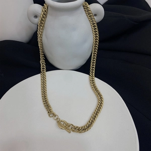 Detailed view of bold golden cuban chain necklace with classic OT toggle clasp design