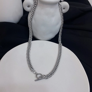 Detailed view of silver thick Cuban chain necklace with minimalist O-T toggle clasp
