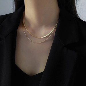 Double layered gold necklace featuring a sleek snake chain and delicate link chain