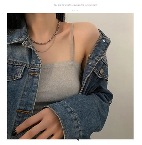 Detail of layered titanium steel necklace with thick link chain and slim snake chain design