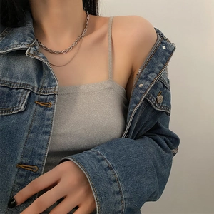 Chic layered silver titanium steel necklace shown on model with denim jacket