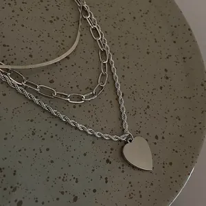 Three-layer silver titanium steel necklace featuring a smooth heart pendant in 45-degree view