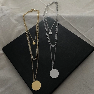 Three-layer layered necklace with round pendant in gold and silver finishes