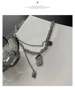 Detailed close-up of double-layered titanium steel tiger pendant necklace with Brave 520 tag