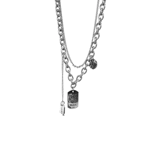 Double-layered silver titanium steel necklace featuring a tiger tag and lucky charm