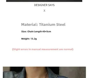 Detailed view of titanium steel gold heart necklace worn over denim jacket for styling