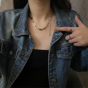 Silver-toned hollow heart link necklace in titanium steel on a fashion-forward model