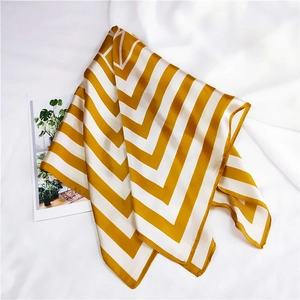 Detailed view of yellow and white striped square silk scarf with neat rolled hem edges