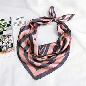 Detail of silk scarf with grey and pink stripes on white textured background