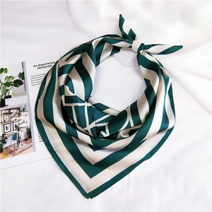 Detail of a square silk-feel scarf with elegant dark green and beige geometric stripes