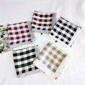 Classic checkered square scarves in five colors displayed on textured white fabric