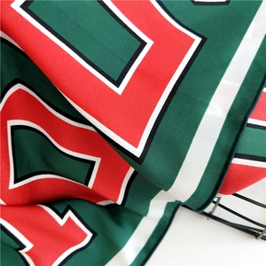 Detailed close-up showing the premium silk texture and geometric print of this square scarf