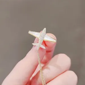 Exquisite gold airplane brooch with mother of pearl wings and sparkling tassels detail