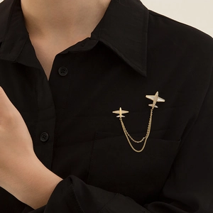 Japanese style gold airplane brooch with tassels and rhinestones on black blazer