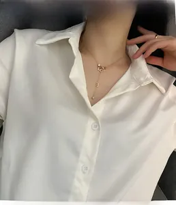 Detailed view of a gold-plated titanium steel necklace with vertical LOVE letter pendant