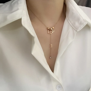Golden Y-shaped LOVE letter necklace with a sparkling round zircon on a fine chain