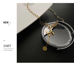 Detailed close-up of golden titanium necklace with H pendant and dual chain design