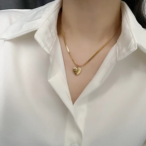 Elegant 18K gold heart pendant necklace featuring Love You More engraving on flat snake chain