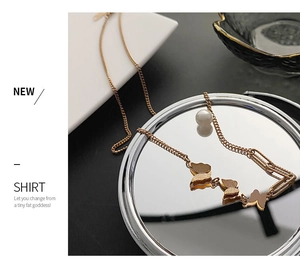 Detailed shot of 18k rose gold butterfly necklace with matte finish and paperclip chain