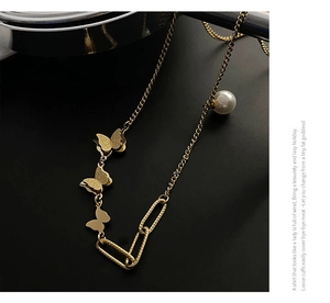 Close-up of 18k rose gold butterfly necklace featuring elegant matte finish and pearls