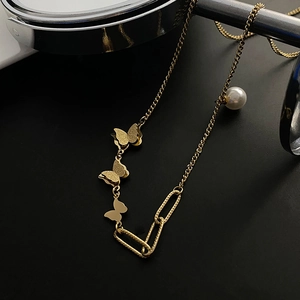 Elegant 18k gold butterfly necklace featuring asymmetric chains and a white pearl accent