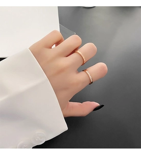 Detail of rose gold two-piece ring set with pave cubic zirconia and Roman numerals