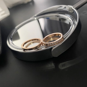 Two-piece rose gold titanium steel ring set with Roman numerals and sparkling cubic zirconia