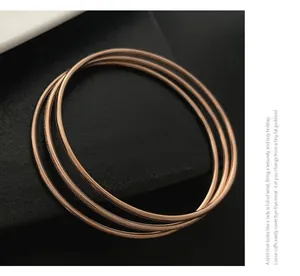 Detail of rose gold triple ring bracelets with polished and frosted matte finishes