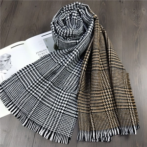Thick autumn cashmere-like scarf with houndstooth pattern and elegant fringe edges