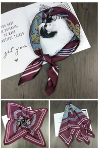 Detail of burgundy satin square scarf with vintage rope patterns and glossy texture