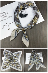 Detail of square silk scarf with vintage chain patterns and geometric stripes texture
