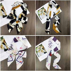 Detail of satin skinny scarves featuring pop art letters and colorful card motifs