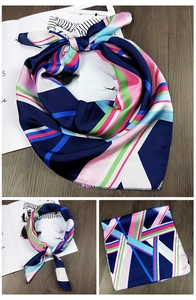 Detail eines geometrisch gestreiften Satin-Halstuchs mit marineblauen und rosa Seidenmustern