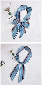 Detail showing various tying methods of a light blue and red striped twillie silk scarf