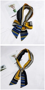 Detail of colorful geometric twilly scarves in vibrant blue and yellow satin fabric